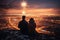 Rear view of silhouettes of a couple watching the fireworks over a city on the top of the mountain on New Year\\\'s Eve