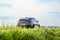 Rear view of a sleek 2023 Hyundai i30 Fastback N Performance vehicle parked in a grassy landscape