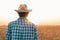 Rear view of soybean farmer looking at field