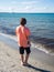 Rear view of a teenager boy on the beach