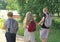 rear view of teenagers going to high school. generation z concept. a teen girl with long curly hair and two boys coming