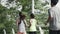 rear view of three young asian people running outdoors on road