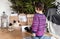 Rear view of toddler girl standing next to holiday gifts. Merry Christmas and Happy New Year! Cute little child girl choose the