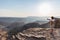 Rear view of tourist looking at expansive view over the Fish River Canyon, scenic travel destination in Southern Namibia. Ultra wi