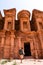 Rear view of tourist man in spectacular view of The Monastery, ancient city of Petra, Jordan