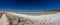 Rear view of tourist walking along Baltinache salar and hidden lagoons