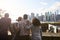 Rear View Of Tourists Looking At Manhattan Skyline