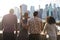 Rear View Of Tourists Looking At Manhattan Skyline