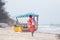 Rear view of traditonaly dressed maasai man selling hand made jewelry on picture perfect tropical Paje beach, Zanzibar