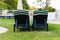 Rear view of two empty green and white sun loungers