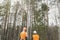 Rear view, two lumberjack looking at the forest