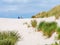 Rear view of two people sitting together on sand dune in nature reserve Het Oerd on West Frisian island Ameland, Friesland,