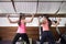 Rear view two women back exercise resistance band