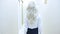 Rear view. unrecognizable beautiful blonde in a short skirt walks down the hall