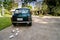 Rear view of a vintage car with just married sign and cans attached and beautiful landscape