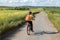 Rear view woman cyclist ride on bike at the dirt road