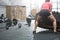 Rear view of woman flipping tire in crossfit gym