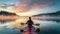 Rear view of a woman navigating her kayak, immersing herself