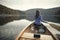 Rear view of woman paddling canoe on lake