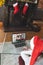 Rear view of woman in santa hat having a videocall with senior couple in santa hats opening gift box