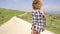 Rear view of woman in shorts walking down hill