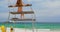 Rear view of woman sitting on observation tower on the beach 4k