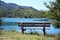 Rear view of a wooden bench on the blue lake overlooking the mountains, Lago della Montagna Spaccata, Alfedena, Abruzzo, Italy