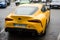 Rear view of yellow Toyota Supra parked in the street