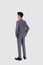 Rear view of young asian businessman in suit hand in pocket with confident  on white background.