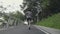 rear view of young asian man running jogging outdoors