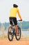 rear view of young bicycle man wearing rider suit and safety helmet riding mountain bike on dirt ground use for man and male act