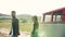 A rear view of young couple on a roadtrip through countryside, walking.