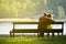 Rear view of a young couple sitting on a park bench. Romantic silhouette of people in love