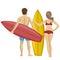 Rear view of young couple standing with their surfboards