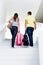 Rear view of young couple walking upstairs to check in on their room in hotel