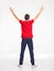 Rear view of young man with lifted hands up, isolated on a white background. Full length body of a guy in a red shirt