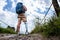 Rear view of a young sporty man with prosthesis standing on the path