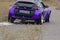 Rear views of the Little Lilac car driving on the road. The Smar