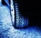 The rear wheel of a car with winter studded tires stands on frozen asphalt in winter. Grip on the road