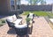 Rear Yard Patio With Wicker Sofa And Chairs On Pavers