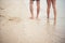 Rear of Young couple walking on the beach with barefoot.