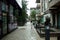 Rear of a young female walking in an alley in downtown Toronto, with the cityscape, Ontario, Canada