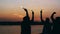 Rearview of friends running together on a beach holding sparkling fireworks. girlfriends girlfriends run along the shore