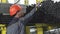 Rearview shot of a male storage worker organizing metal pipes on the shelf