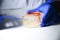 Reasercher picking up colony of a red bacterial culture from agar plate in a molecular biology laboratory for the isolation of