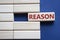 Reason symbol. Concept word Reason on wooden blocks. Beautiful deep blue background. Business and Reason concept. Copy space