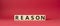 Reason symbol. Concept word Reason on wooden cubes. Beautiful red background. Business and Reason concept. Copy space