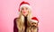 Reasons to love christmas with pets. Girl attractive blonde hold dog pet pink background. Woman with puppy wear santa