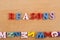 REASONS word on wooden background composed from colorful abc alphabet block wooden letters, copy space for ad text