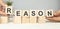 REASONS word written on wood abc block